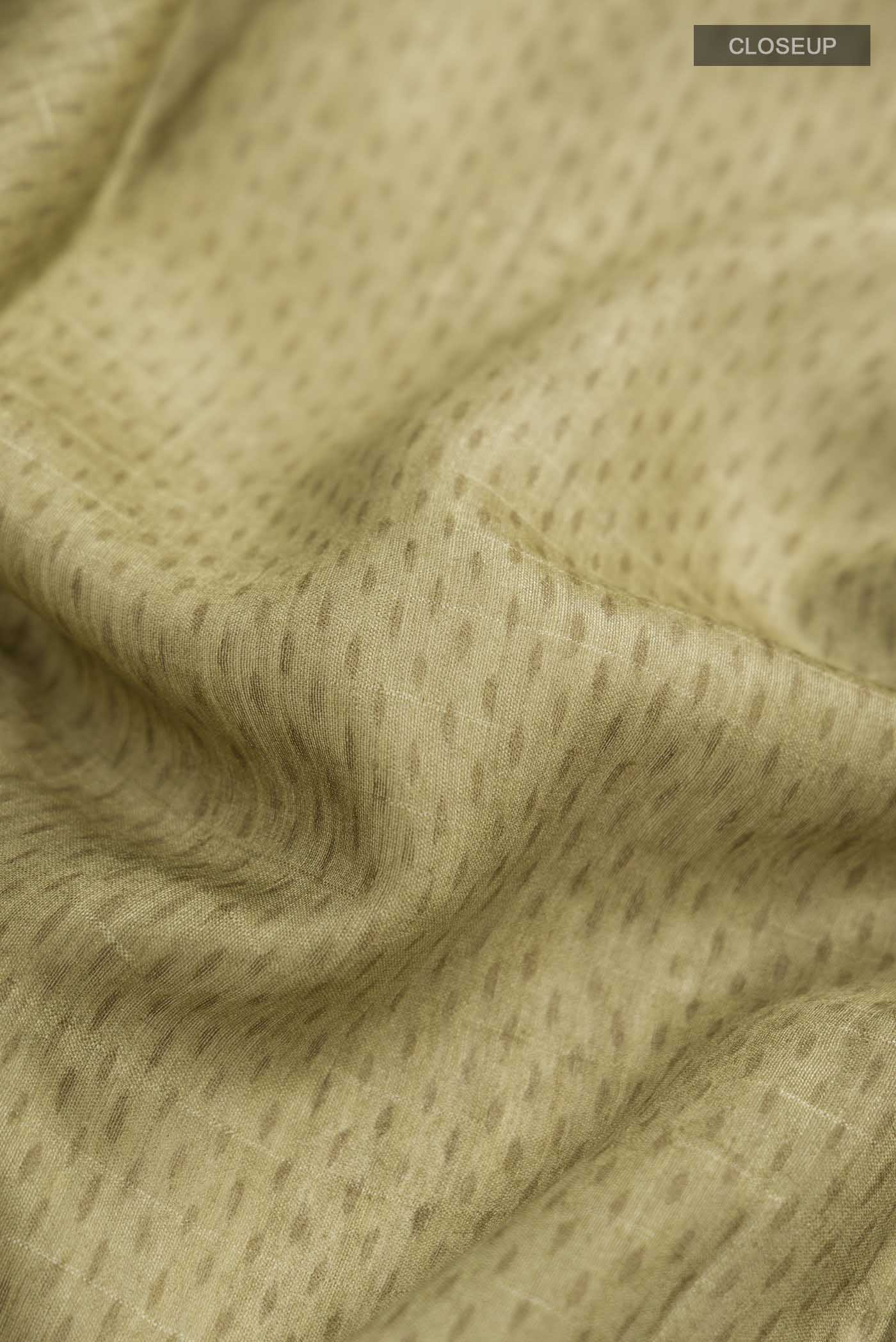 Close up of Green Bhagalpuri Tussar Silk Saree With Printed design on the body and Zari Border displaying folds