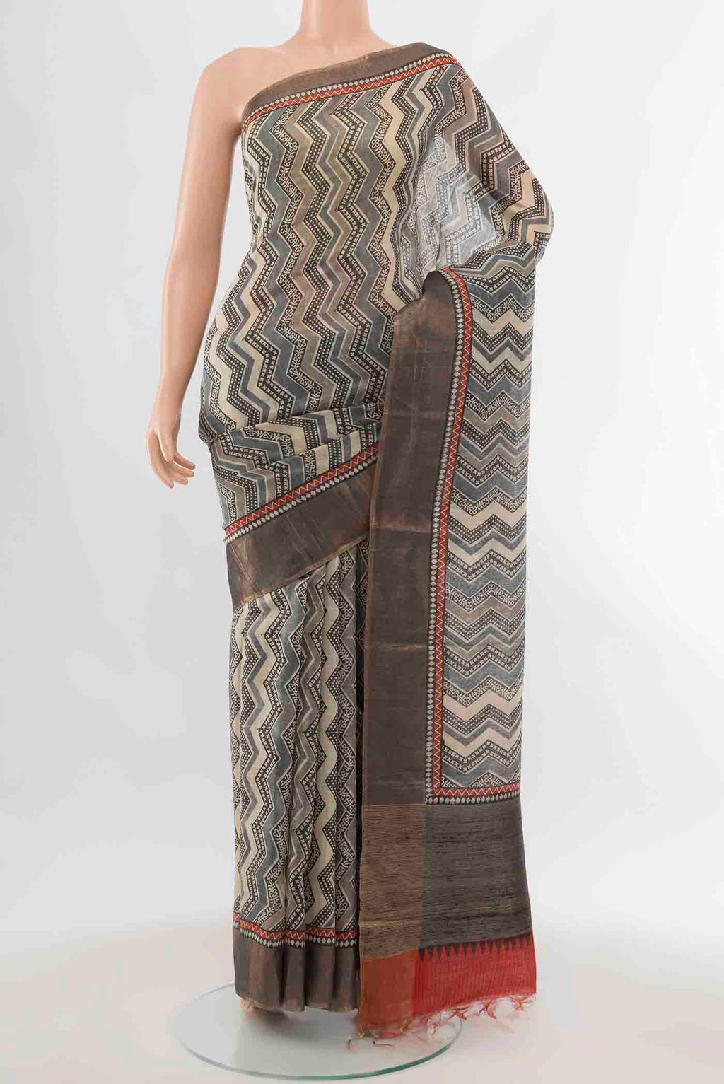 Grey Tussar Silk Saree with Geometric Print on the body and Zari Border displayed on a mannequin