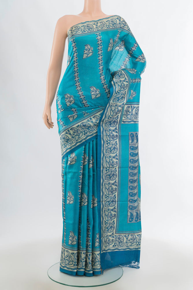 Light Blue Tussar Silk Saree with Floral Print on the body and Silk Border.  displayed on a mannequin