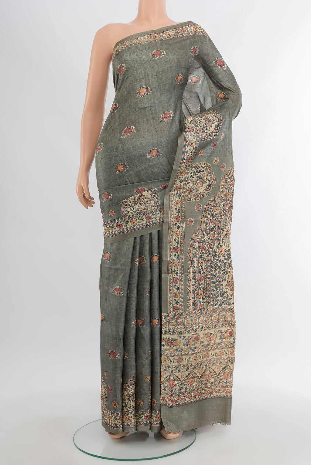 Green Tussar Silk Saree with Printed design on the body and Printed Border.  displayed on a mannequin