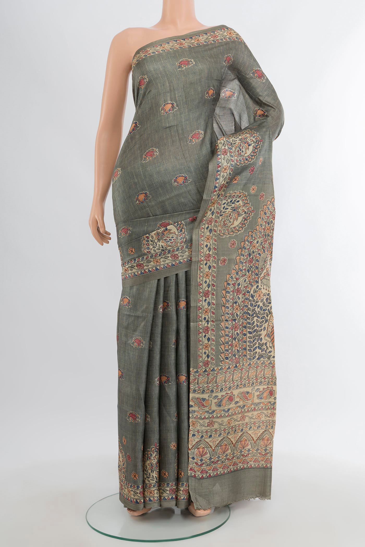 Green Tussar Silk Saree with Printed design on the body and Printed Border.  displayed on a mannequin
