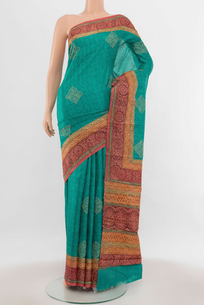 Peacock Blue Tussar Silk Saree with Floral Print on the body and Thread Border.  displayed on a mannequin