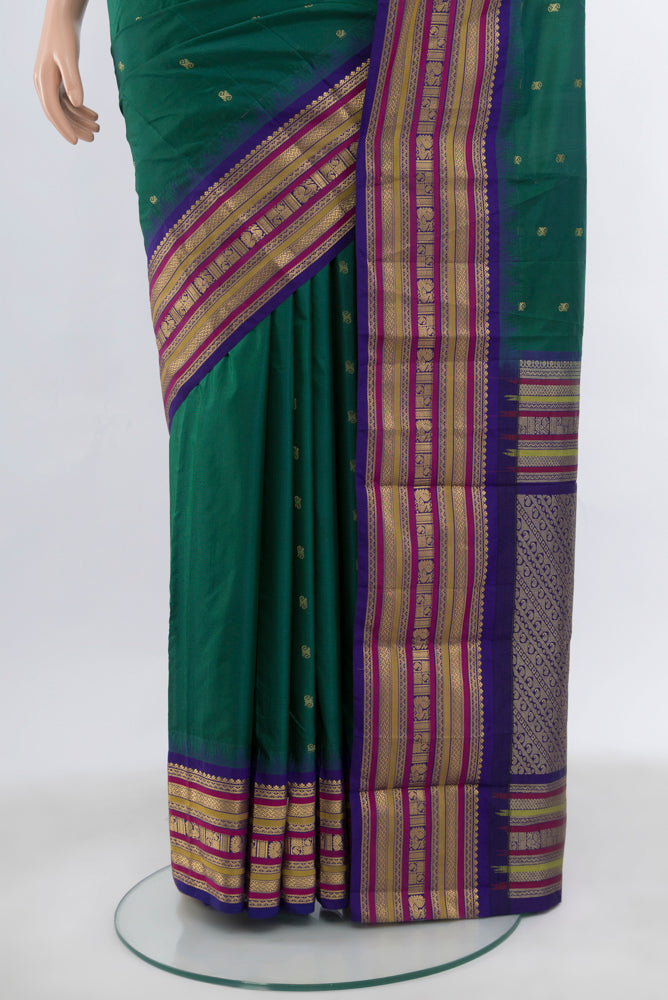 Pleats and pallu of Peacock Blue Bangalore Silk Saree with Zari Butta on the body and Silk Border. 