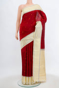 Maroon Kanjivaram Silk Saree with Zari Butta on the body and Silk Border.  displayed on a mannequin
