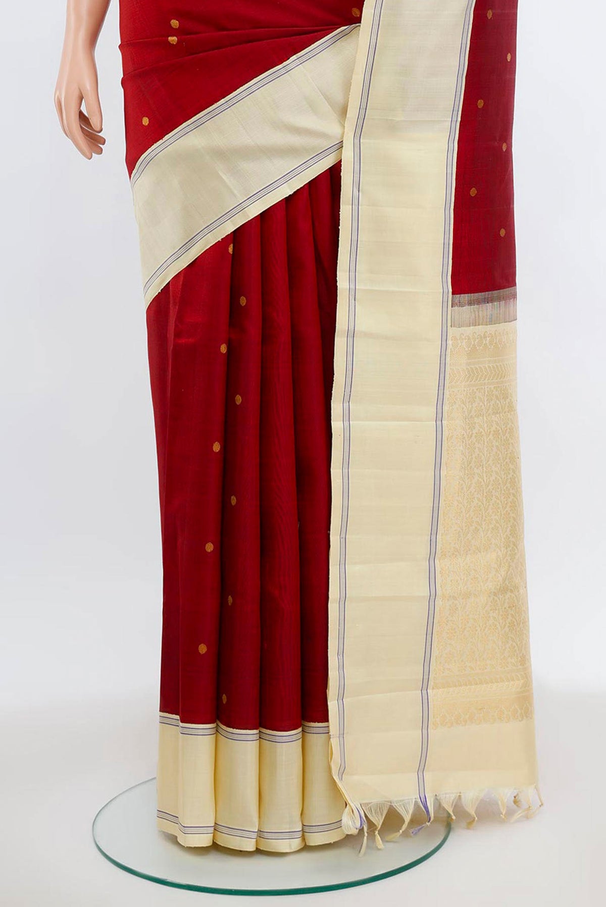 Pleats and pallu of Maroon Kanjivaram Silk Saree with Zari Butta on the body and Silk Border. 