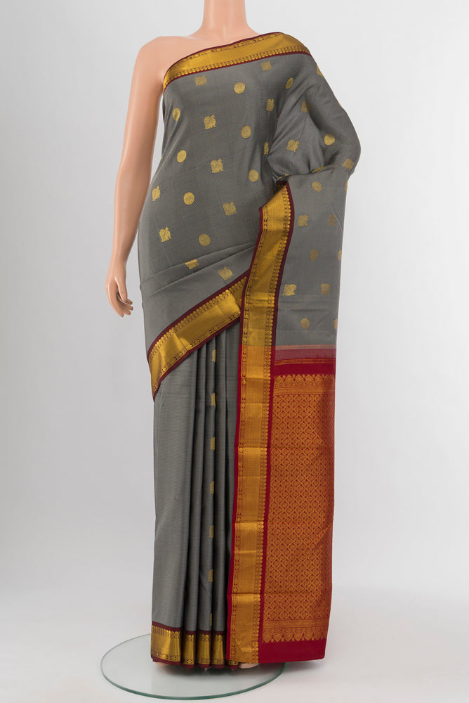 Davys Grey Kanchipuram Silk Saree with Zari Butta on the body and Silk Border.  displayed on a mannequin
