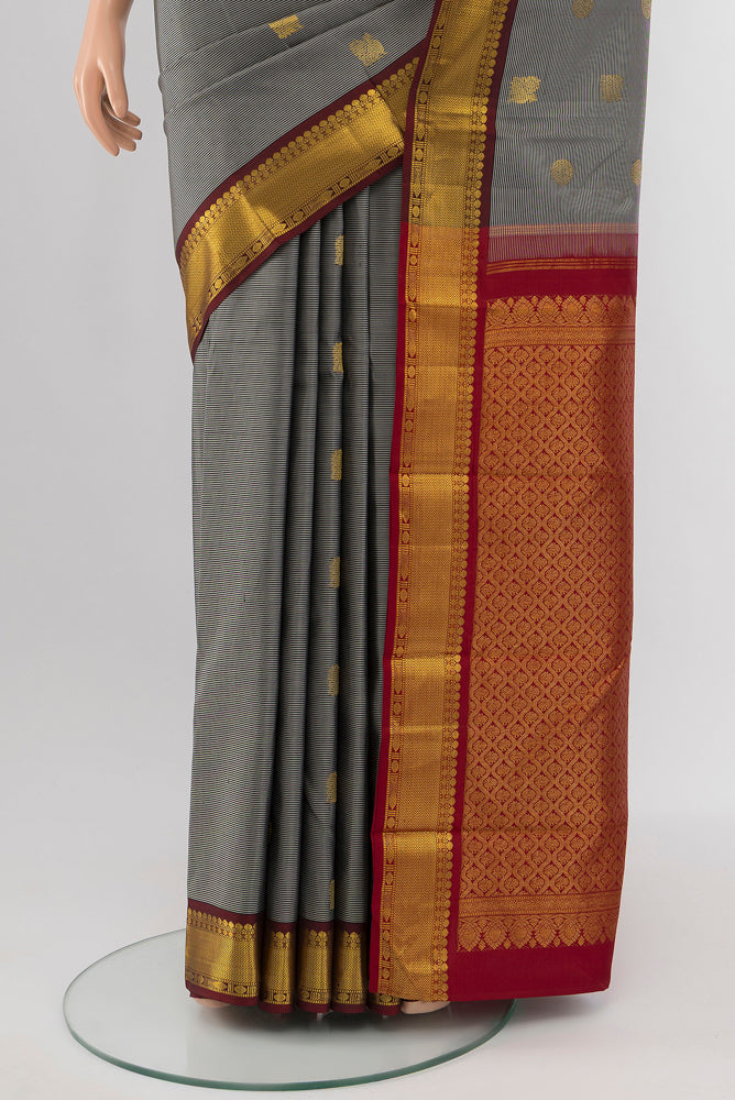 Pleats and pallu of Davys Grey Kanchipuram Silk Saree with Zari Butta on the body and Silk Border. 