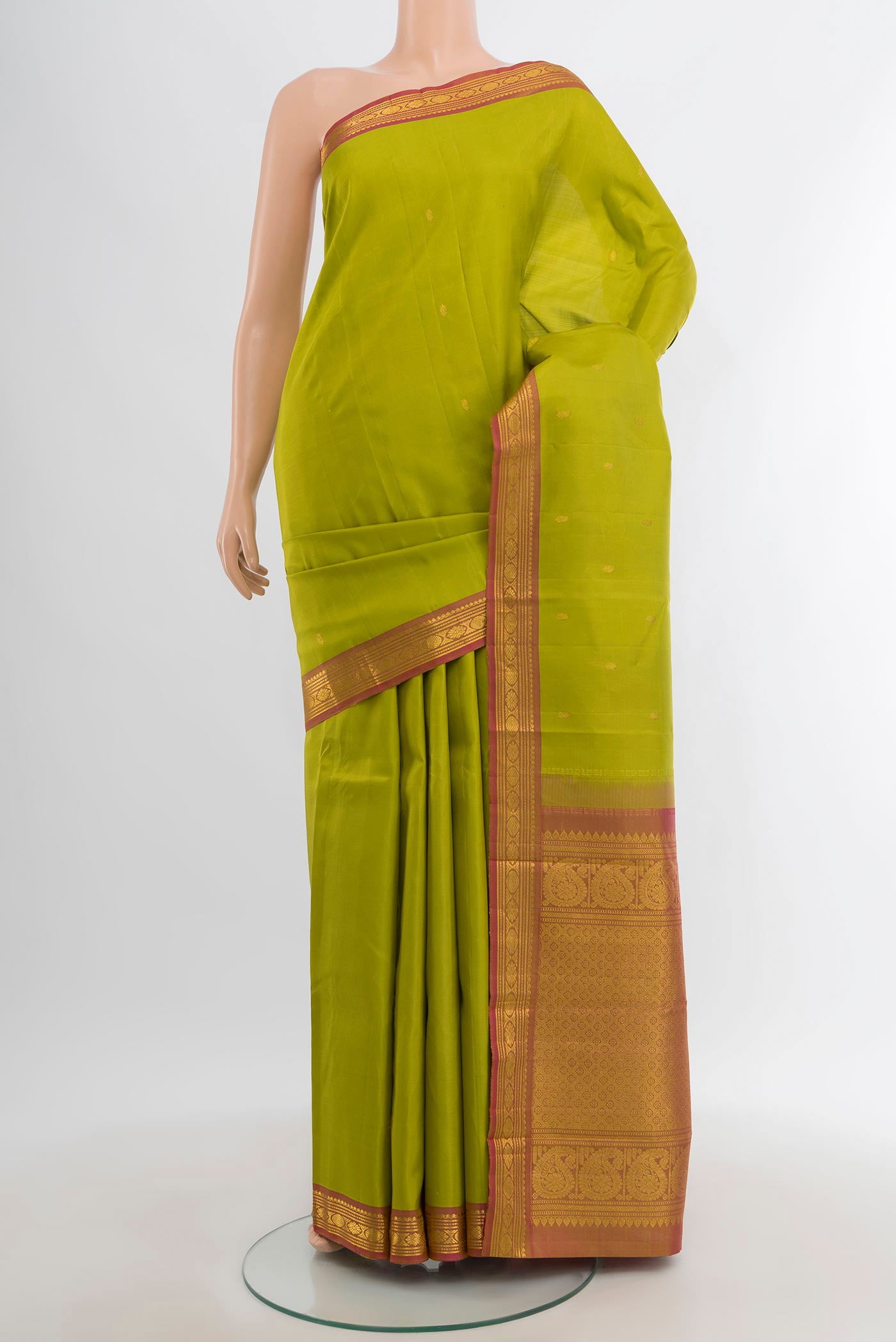 Light Green Kanchipuram Silk Saree with Zari Butta on the body and Zari Border.  displayed on a mannequin