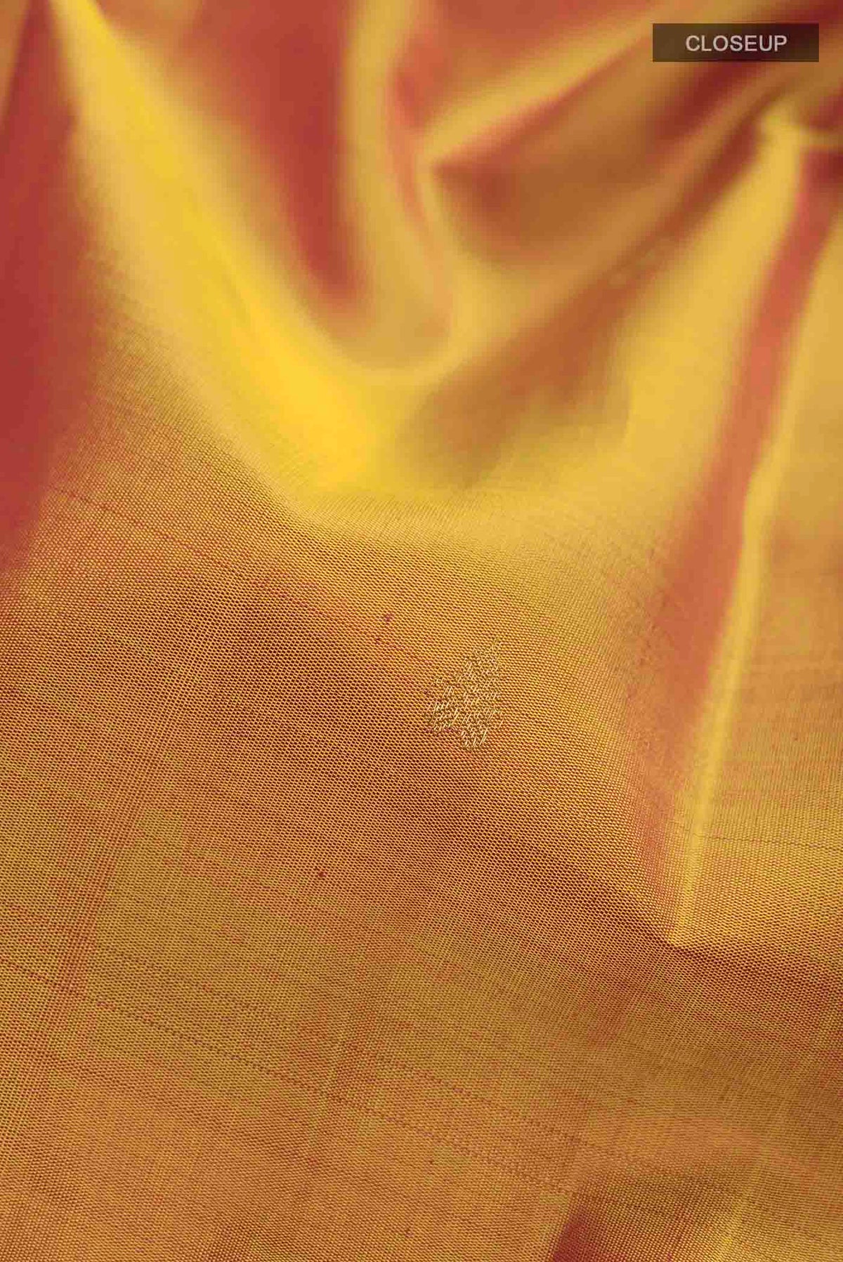Close up of Mustard Kanchipuram Silk Saree with Zari Butta on the body and Zari Border displaying folds