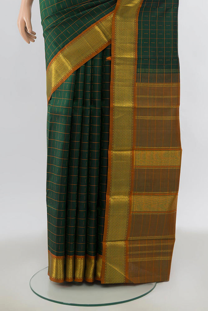 Pleats and pallu of Green Kanchipuram Silk Saree with Zari Butta on the body and Silk Border. 
