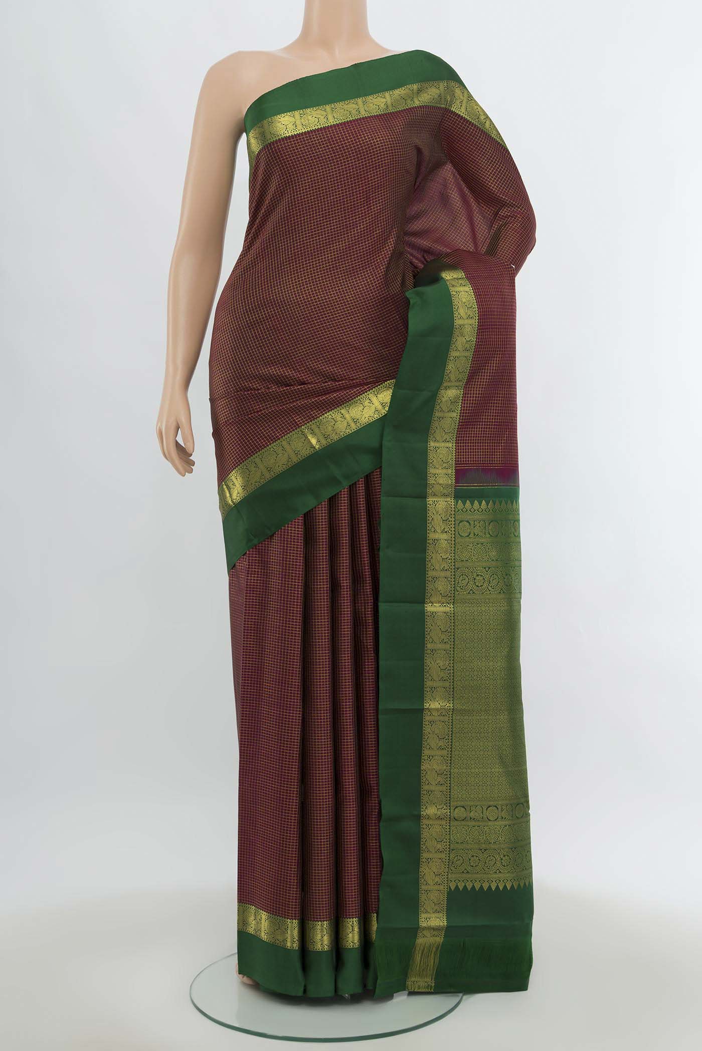 Maroon Kanchipuram Silk Saree with Zari Butta on the body and Silk Border.  displayed on a mannequin