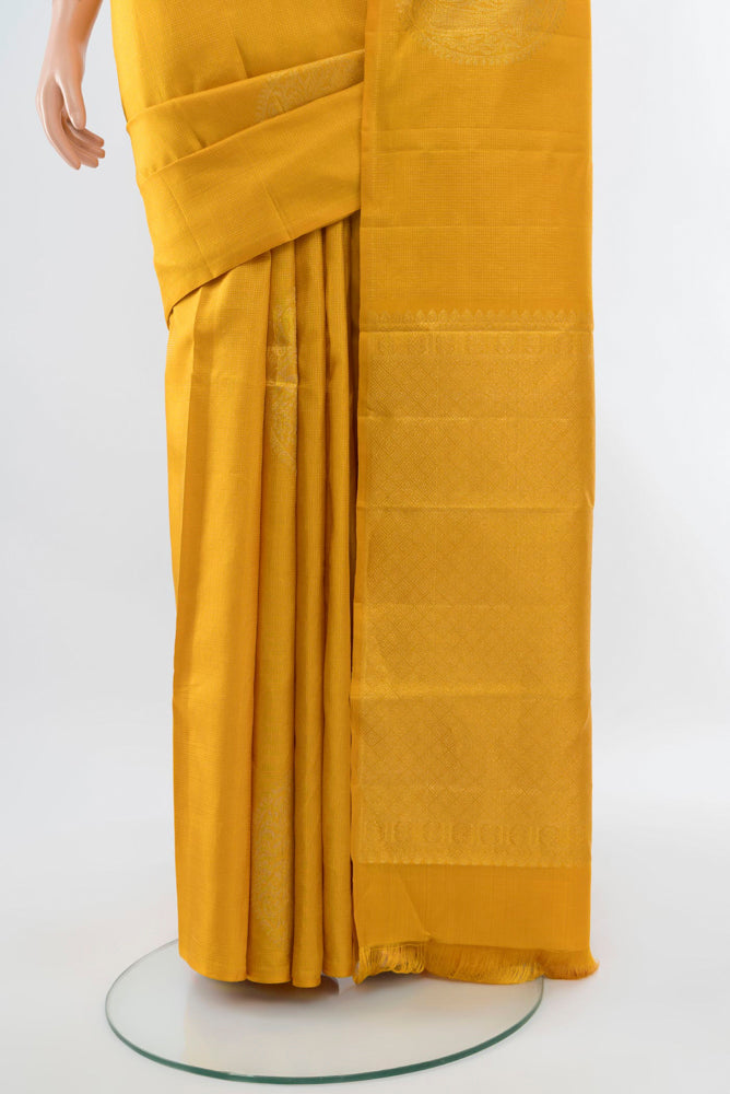 Pleats and pallu of Yellow Kanjivaram Silk Saree with Zari Butta on the body and Silk Border. 
