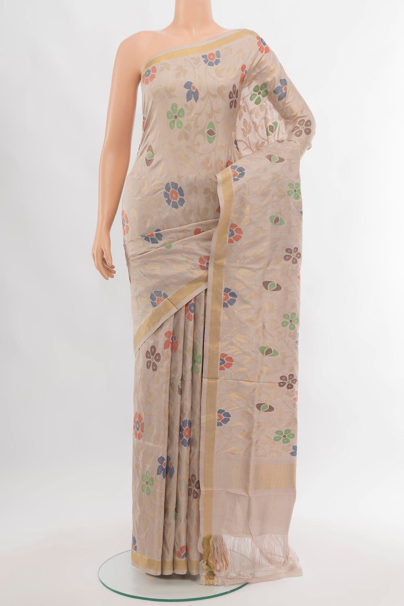 Beige Uppada Silk Saree with Zari Butta on the body and Silk Border.  displayed on a mannequin