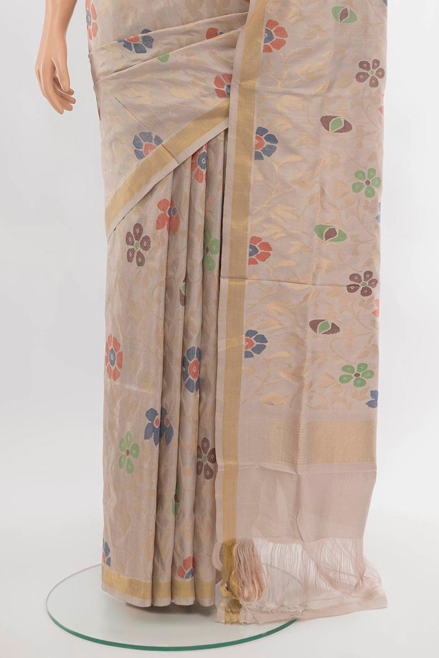 Pleats and pallu of Beige Uppada Silk Saree with Zari Butta on the body and Silk Border. 
