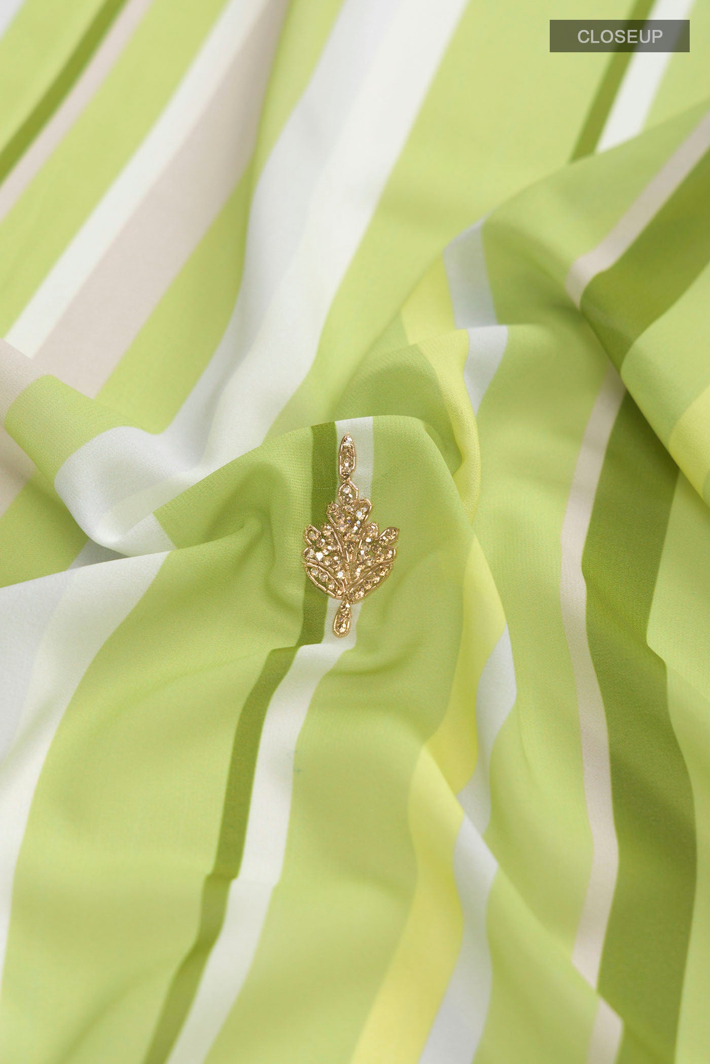 Close up of Green Georgette Saree with Embroidery on the body and Embroidery Border displaying folds