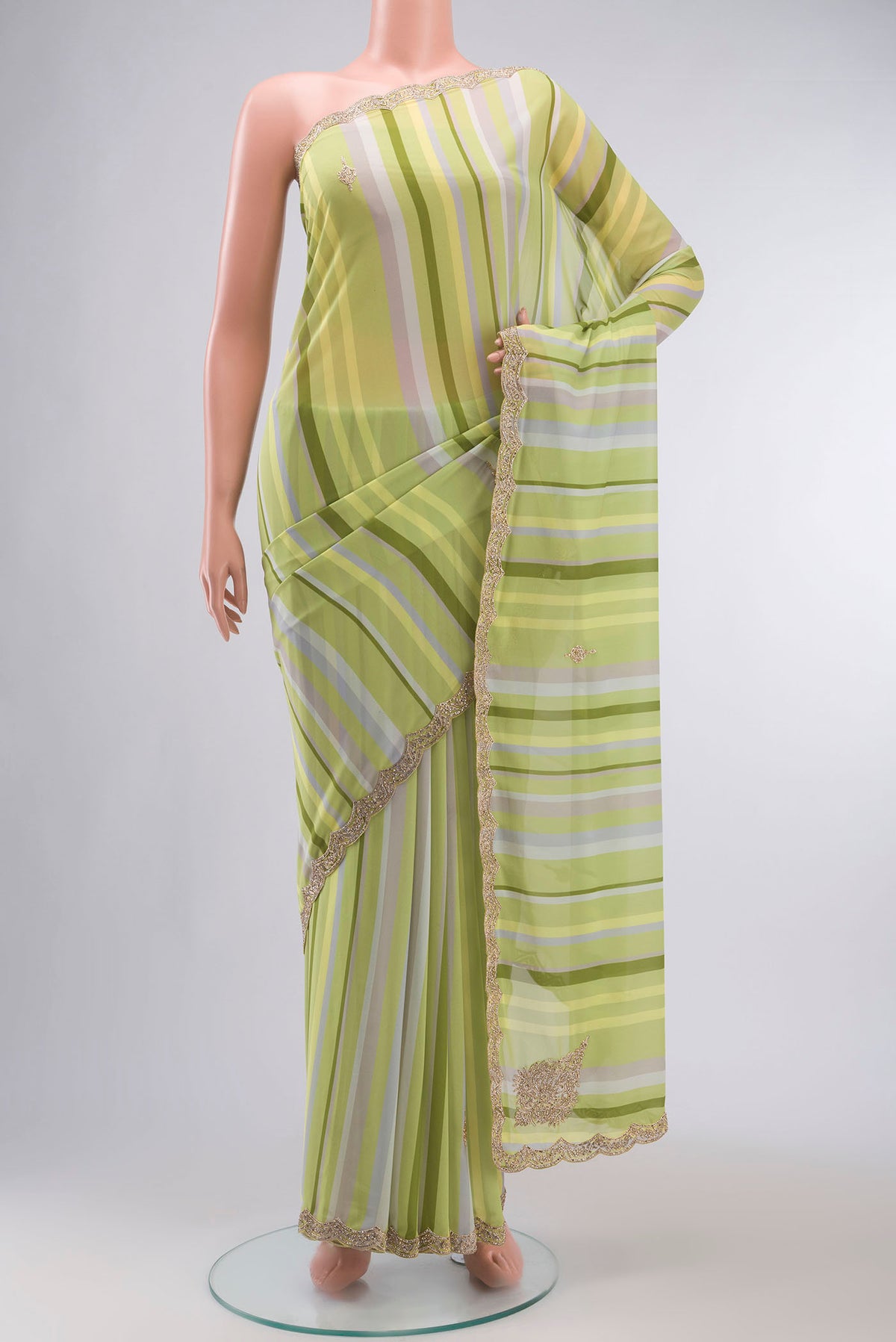 Green Georgette Saree with Embroidery on the body and Embroidery Border displayed on a mannequin