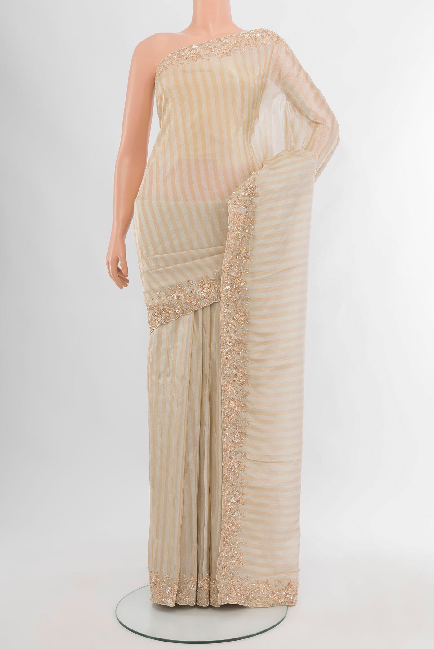 Cream Blended Tissue Silk Saree with Embroidery on the body and Embroidery Border.  displayed on a mannequin