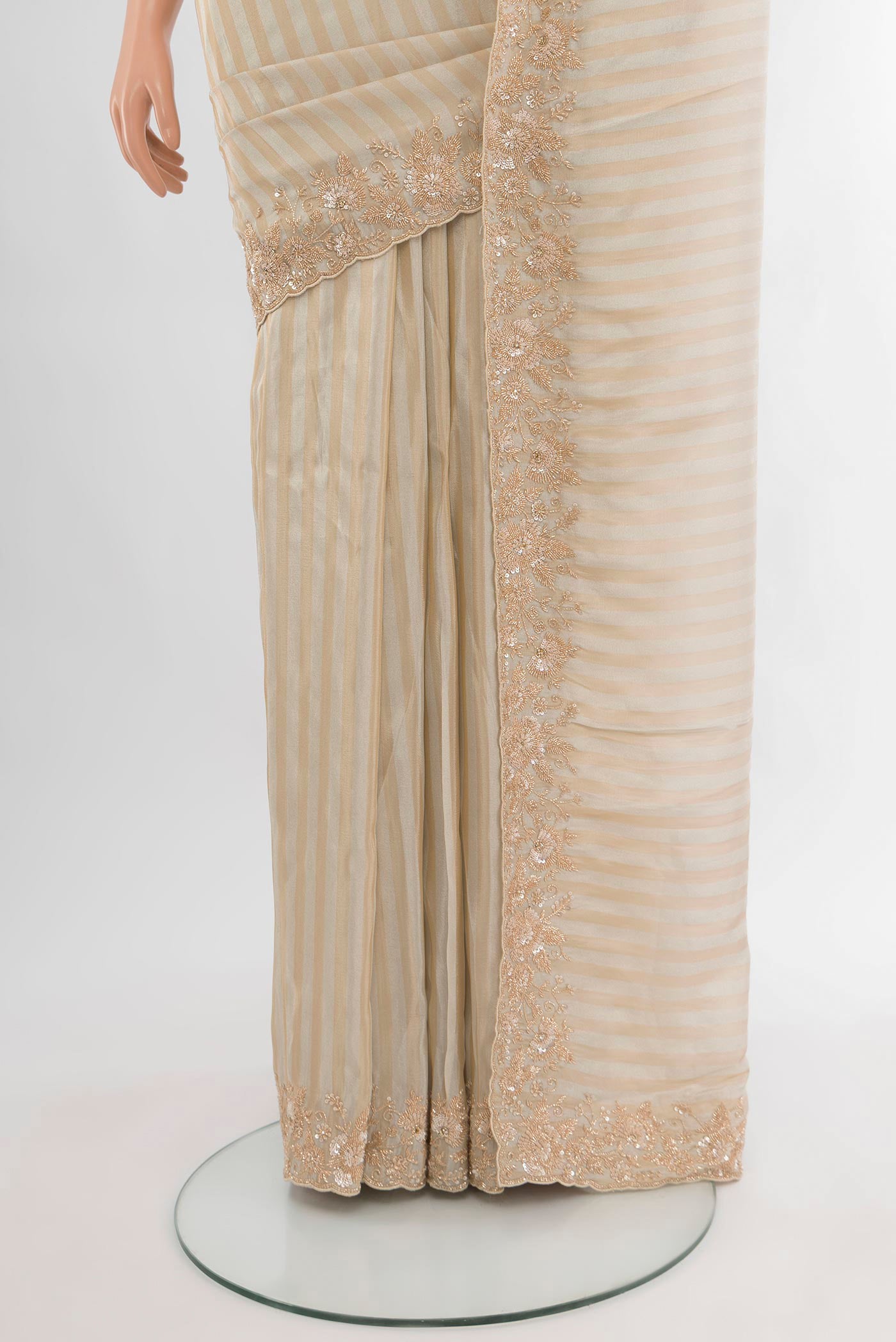 Pleats and pallu of Cream Blended Tissue Silk Saree with Embroidery on the body and Embroidery Border. 