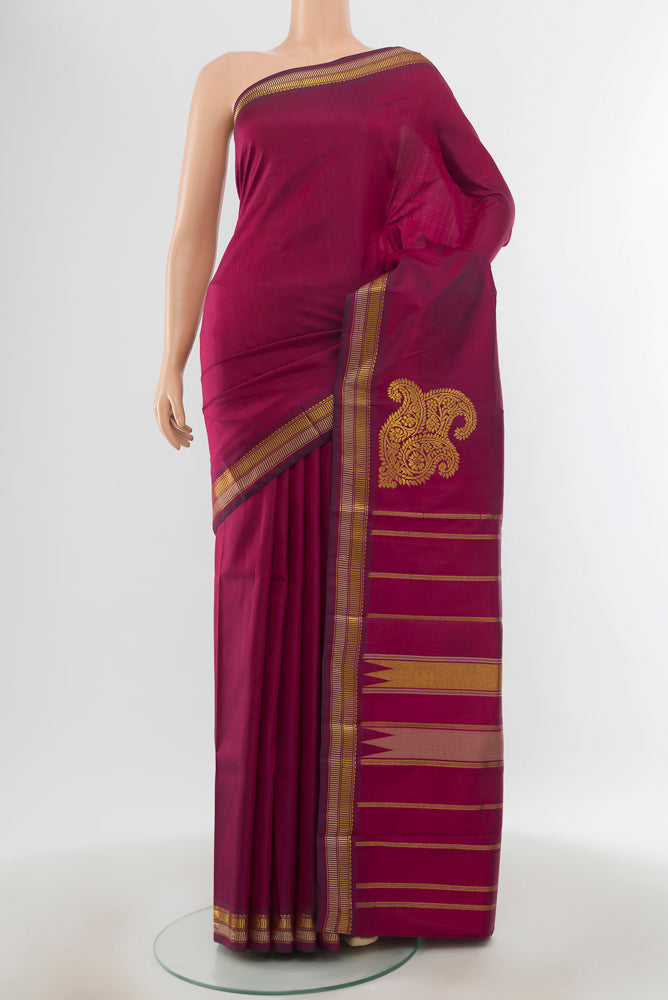 Pure Silk Pure Zari Purple Kanchipuram Saree with Zari Butta on the body and Silk Border.  displayed on a mannequin