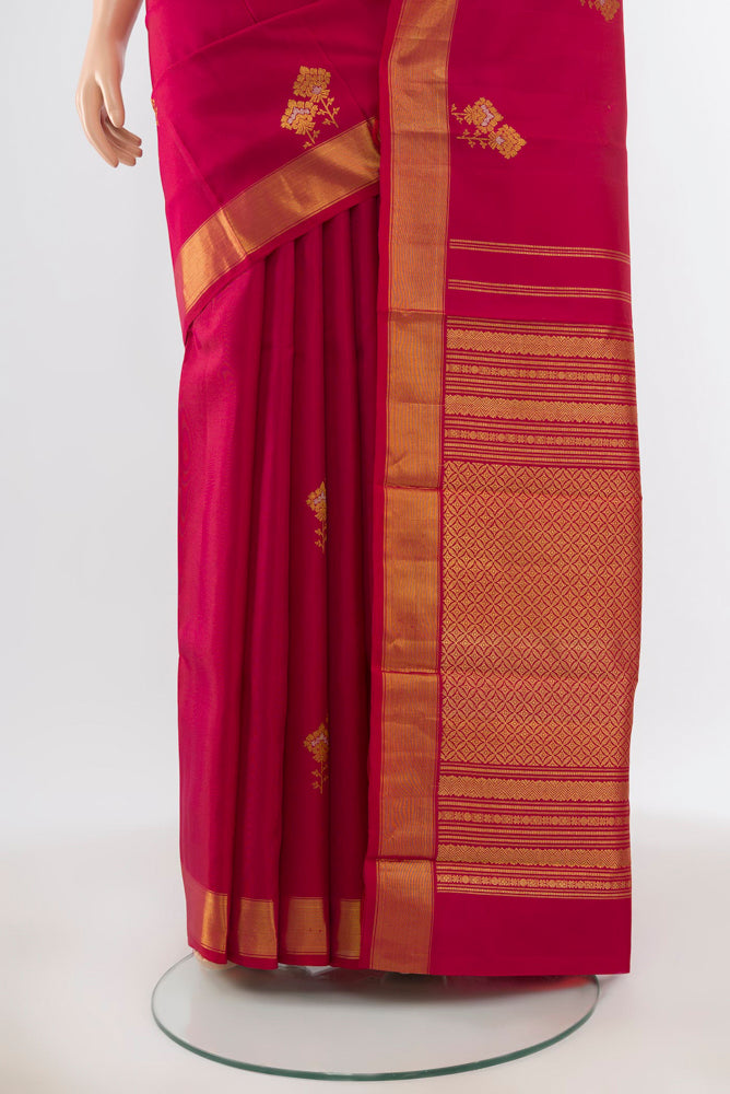 Pleats and pallu of Pure Silk Pure Zari Maroon Kanjivaram Saree with Zari Butta on the body and Silk Border. 