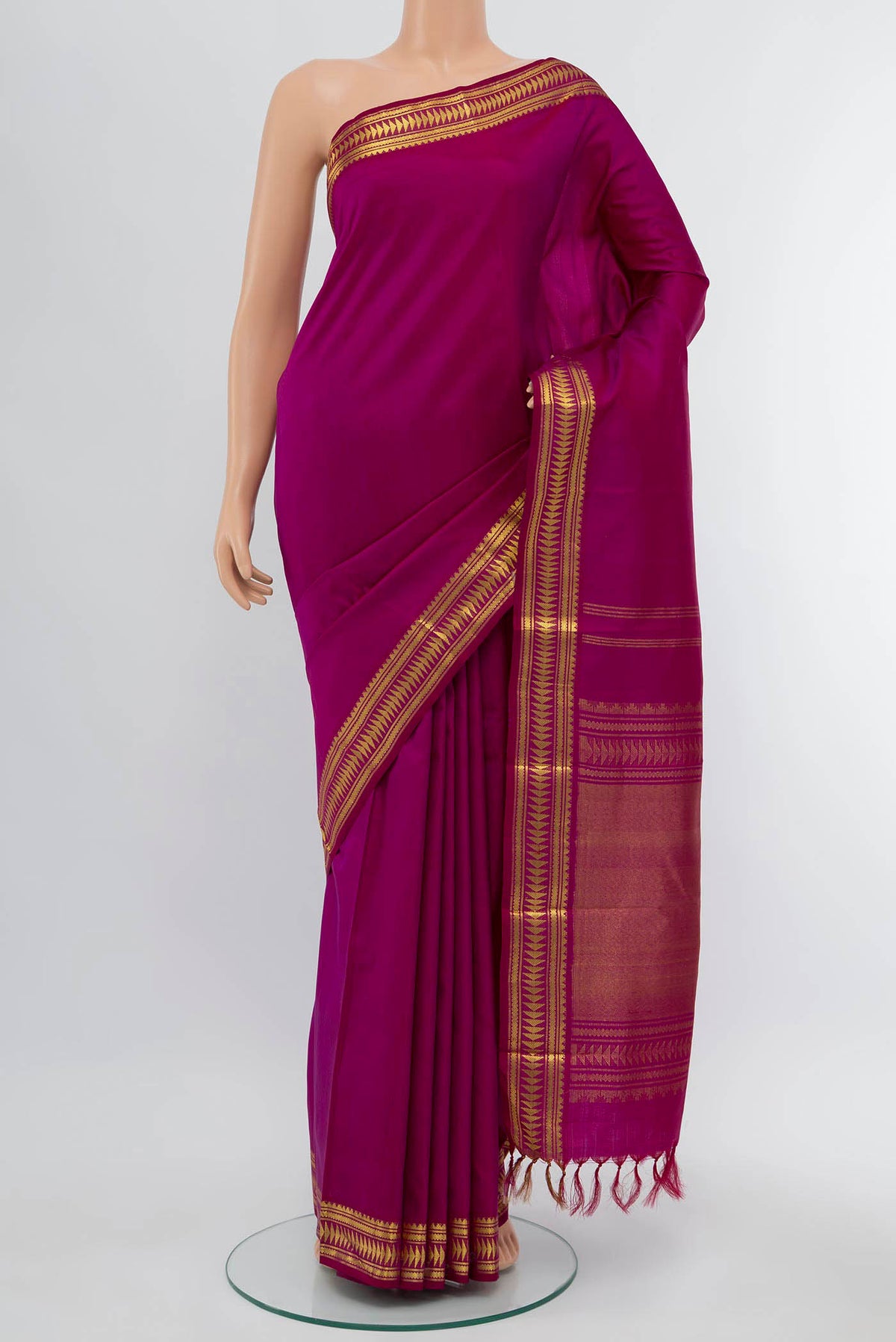 Magenta Kanchipuram Silk Saree with Plain Body and Fancy Border displayed on a mannequin