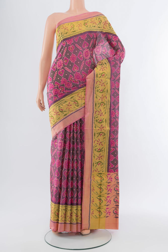Multi Color Rajkot Patola Silk Saree with Ikat Print on the body and Silk Border.  displayed on a mannequin