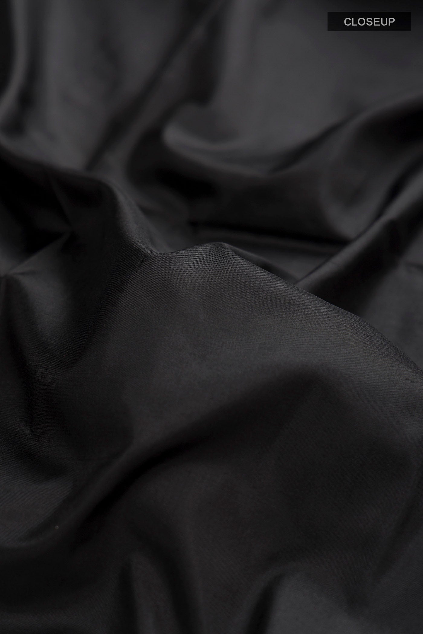 Close up of Black Bangalore Silk Saree with Plain Body and Checks Border displaying folds