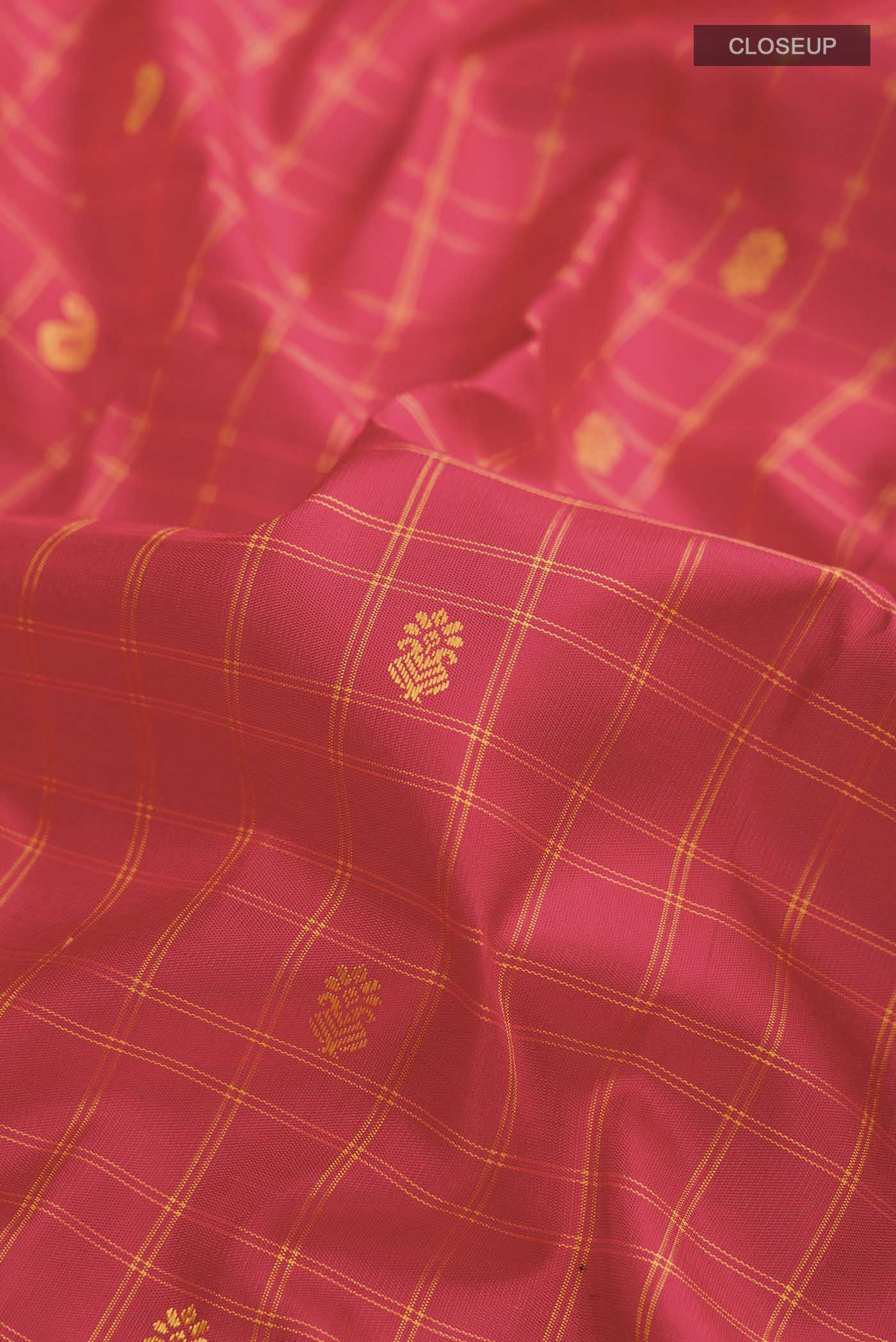 Close up of Red Gadwal Silk Saree with Thread Butta on the body and Thread Border displaying folds