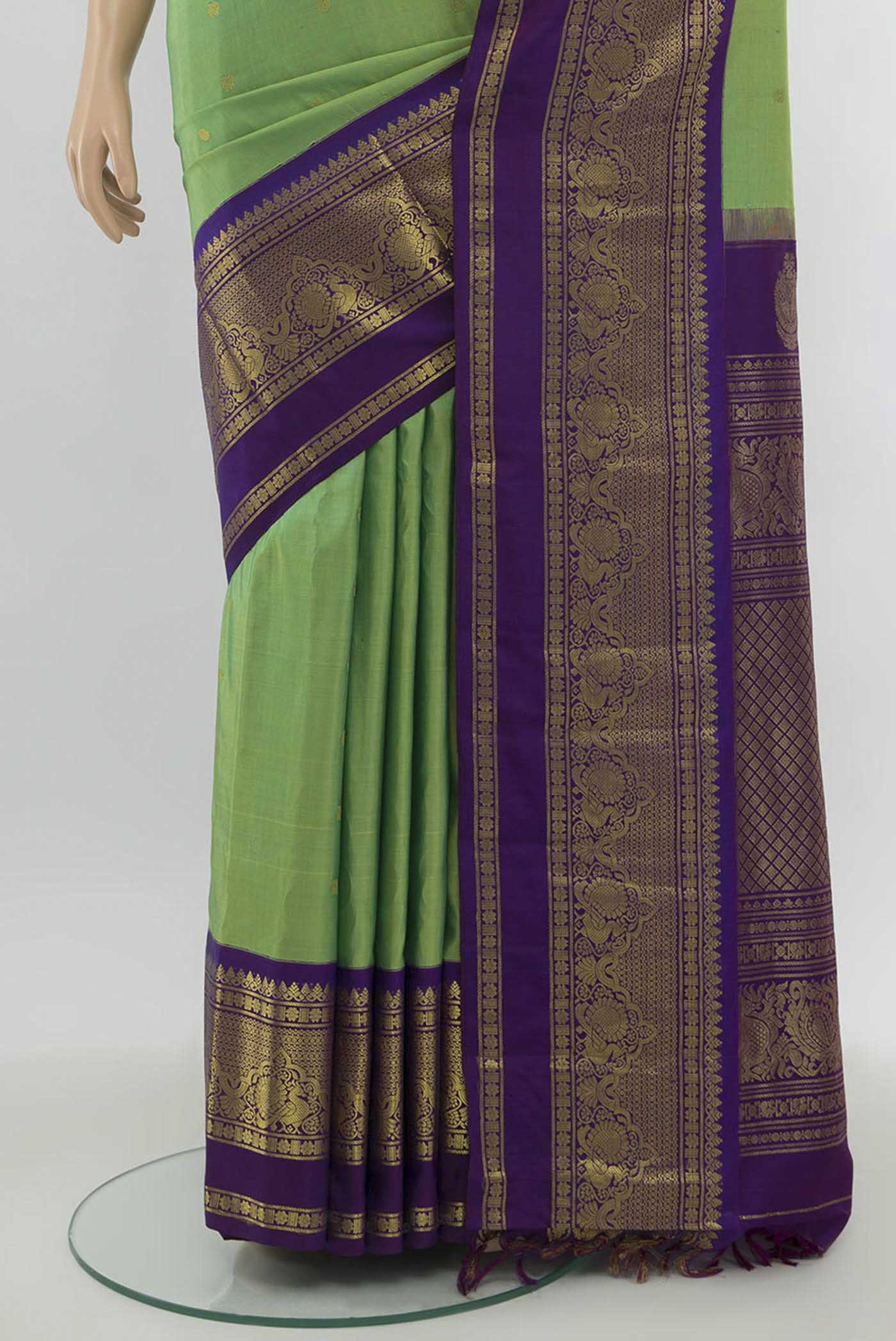 Pleats and pallu of Parrot Green Gadwal Silk Saree with Zari Butta on the body and Silk Border. 