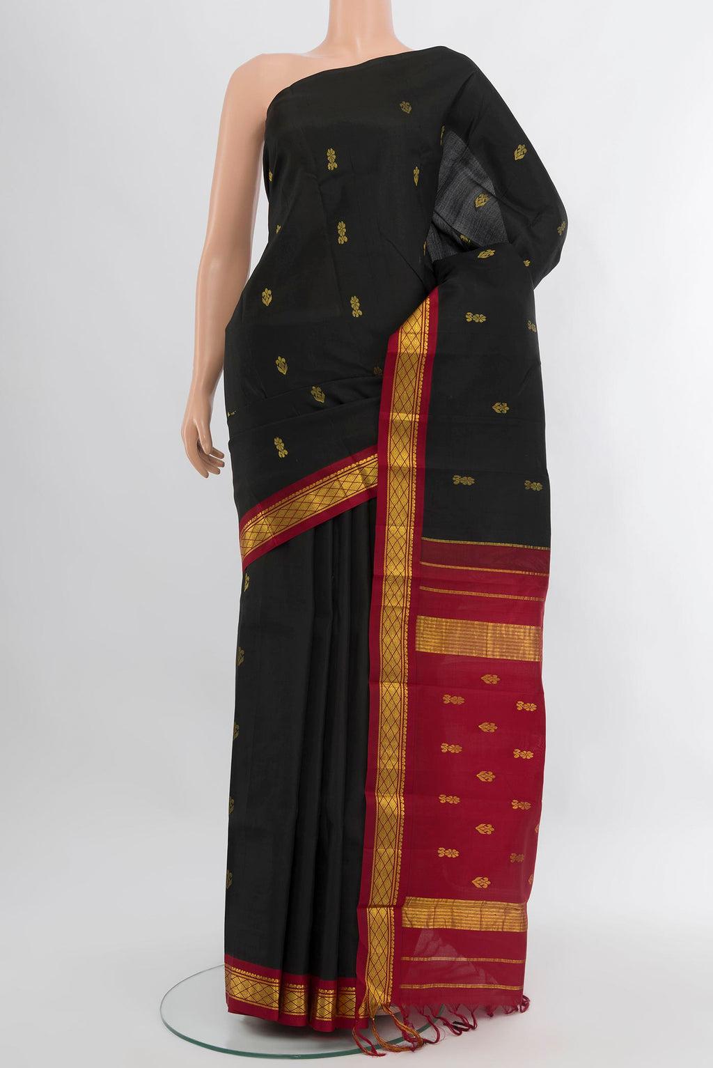 Black Kanchipuram Silk Saree with Zari Butta on the body and One Side Border.  displayed on a mannequin