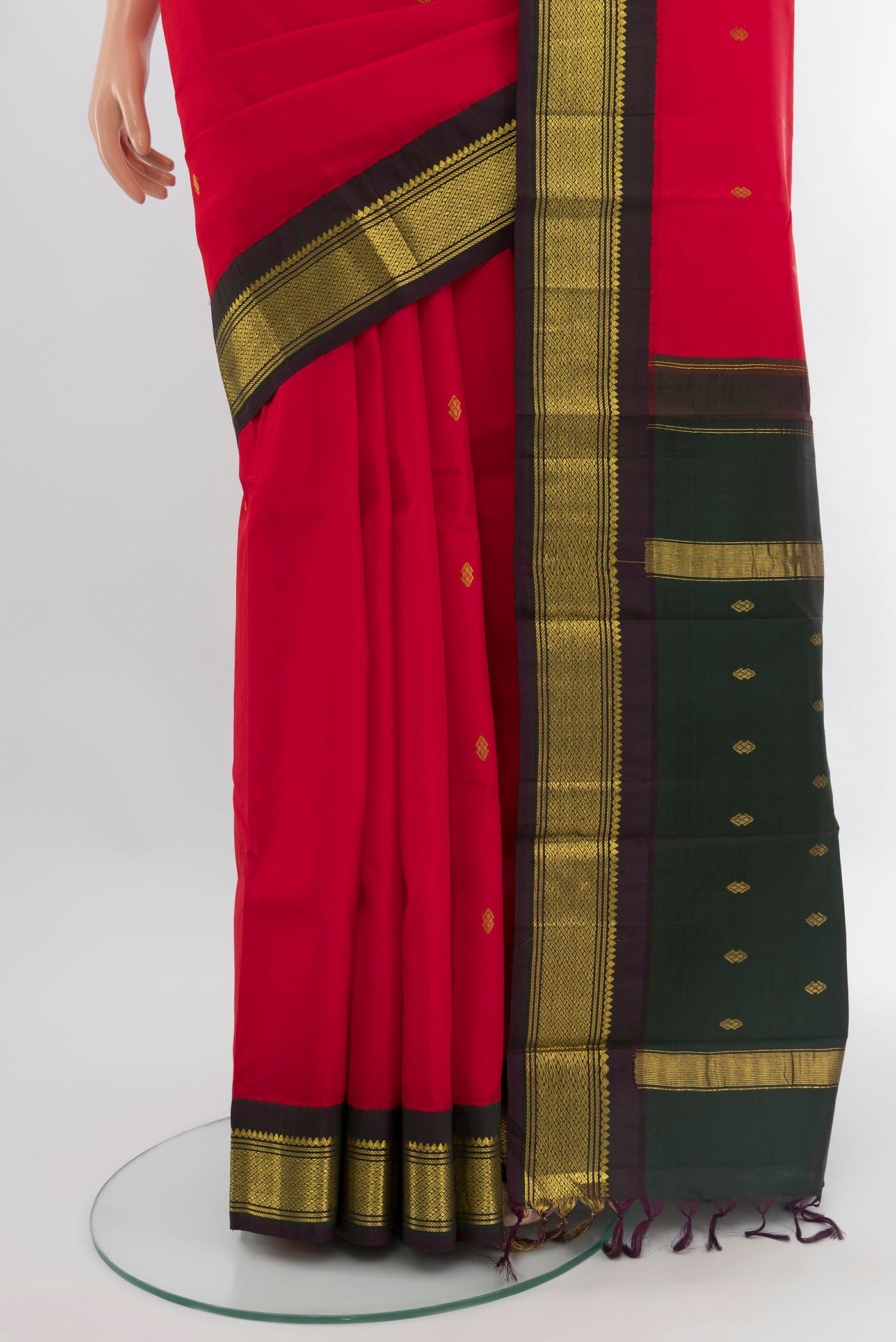 Pleats and pallu of Red Kanchipuram Silk Saree with Zari Butta on the body and One Side Border. 