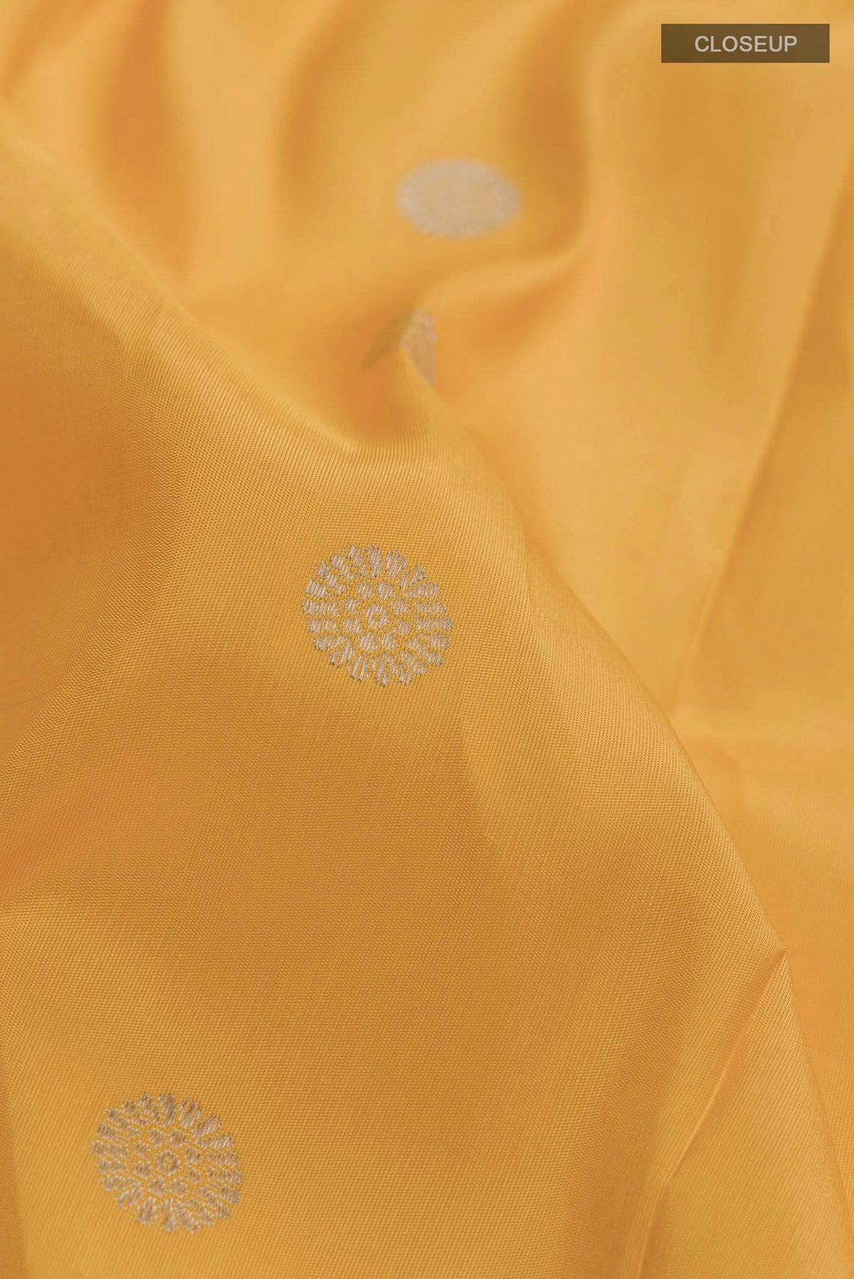 Close up of Yellow Paithani Silk Saree with Zari Butta on the body and Zari And Thread Border displaying folds