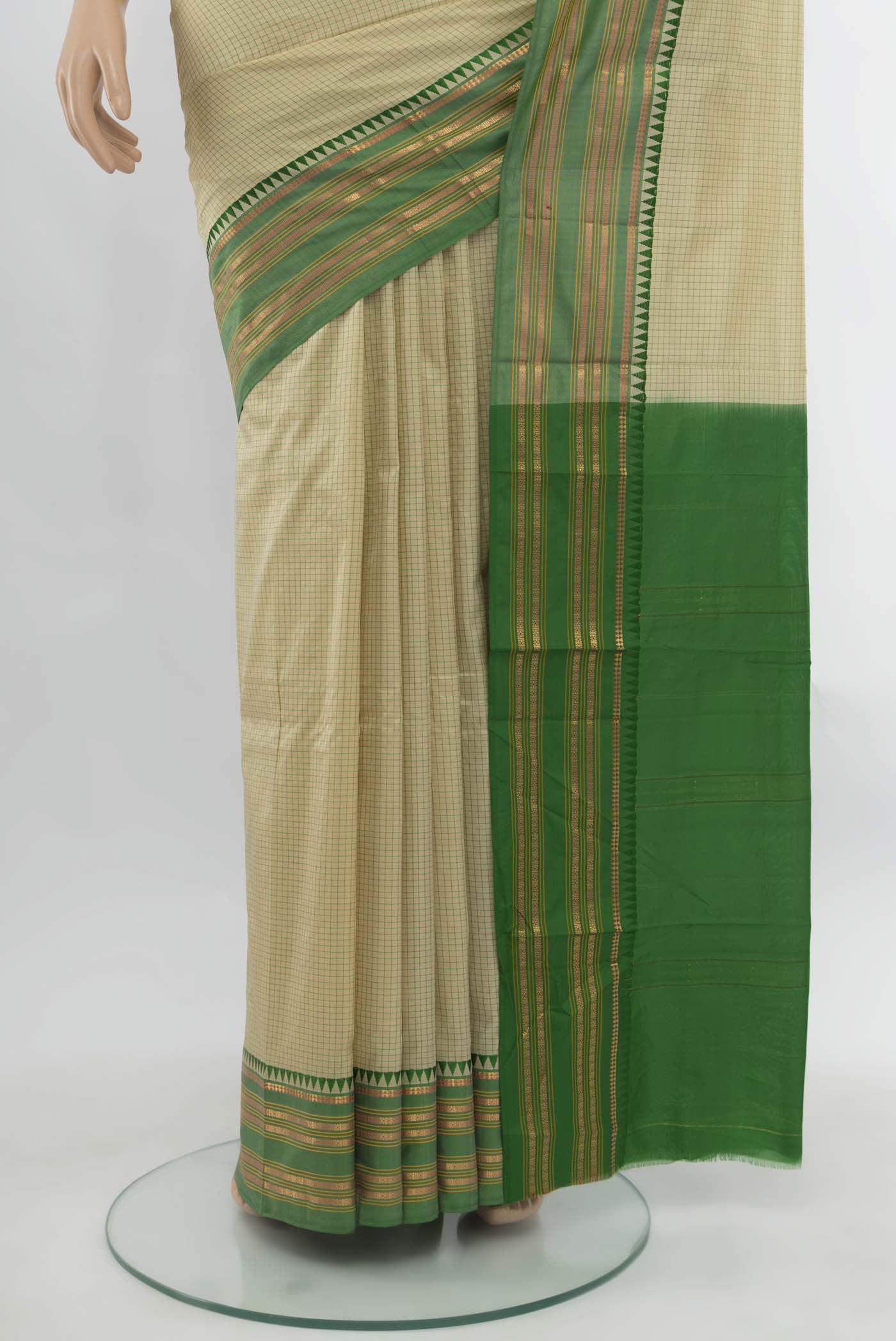 Pleats and pallu of Cream Narayanpet Silk Saree with Zari Butta on the body and Silk Border. 