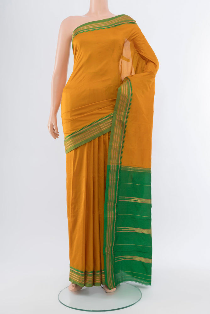Mustard Narayanpet Silk Saree with Plain Body and Silk Border.  displayed on a mannequin