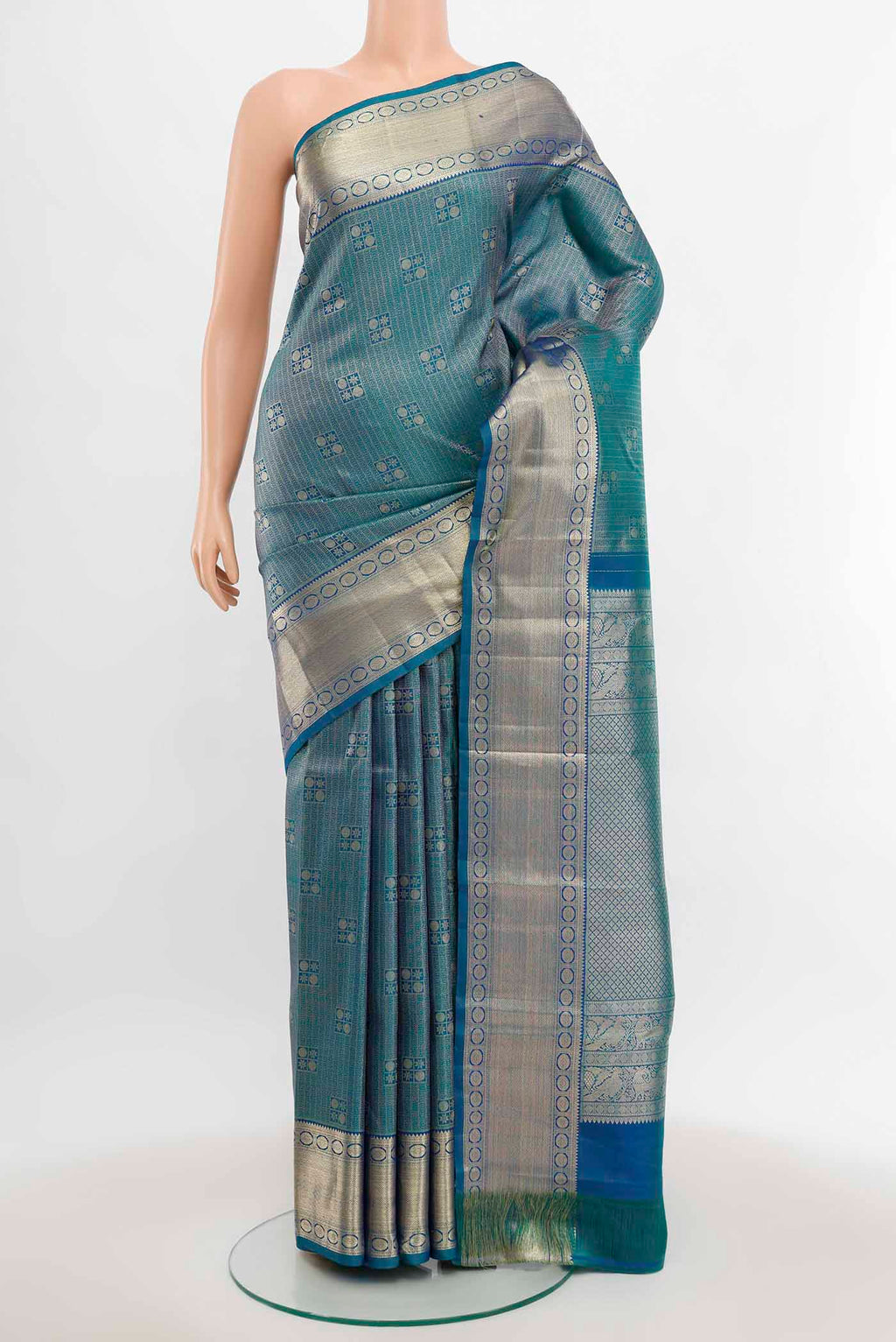 Peacock Blue Kanchipuram Silk Saree with Zari Butta on the body and Silk Border.  displayed on a mannequin