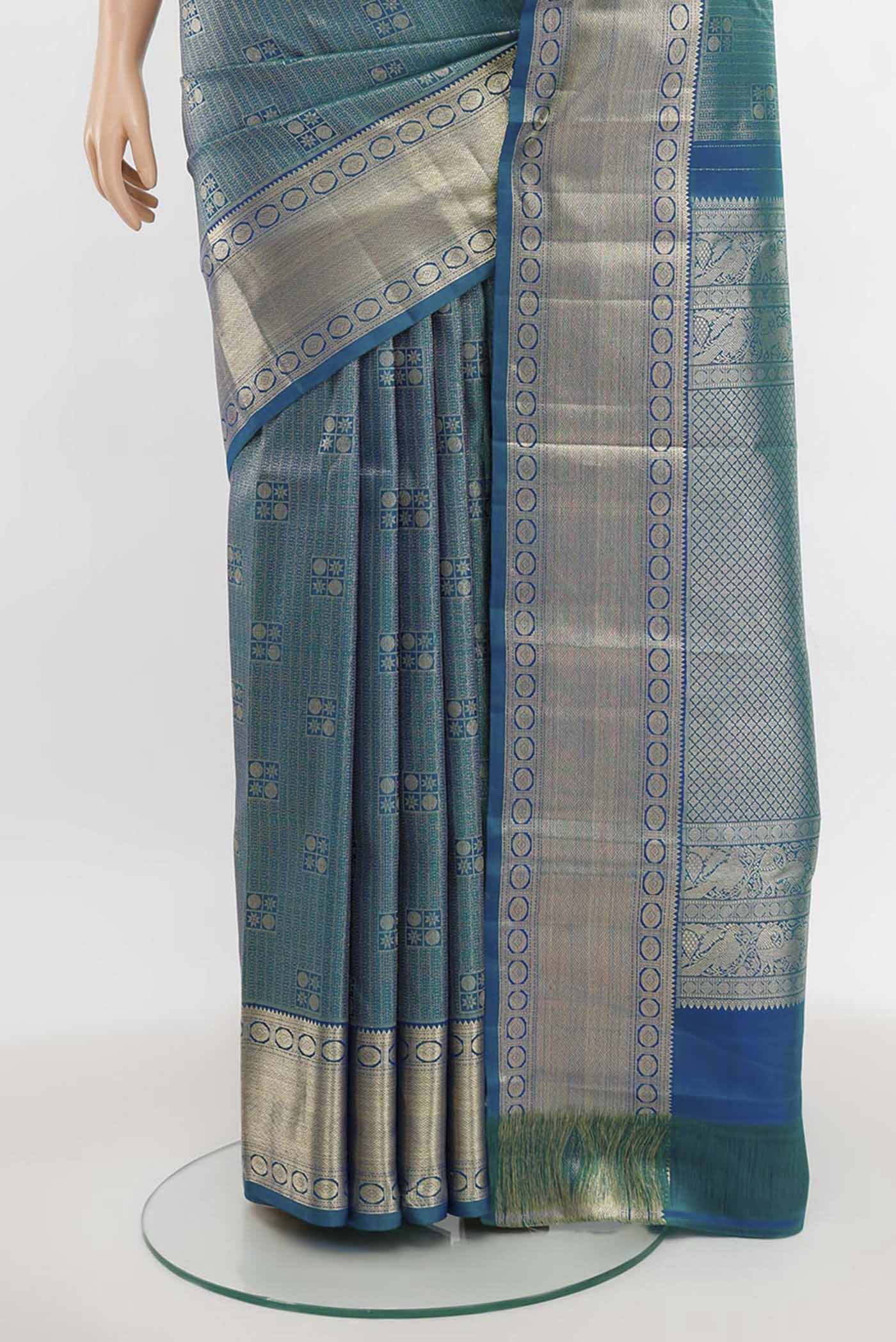 Pleats and pallu of Peacock Blue Kanchipuram Silk Saree with Zari Butta on the body and Silk Border. 
