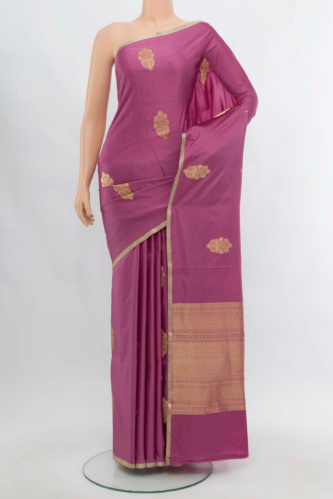Light Magenta Banarasi Katan Silk Saree with Zari Butta on the body and Silk Border.  displayed on a mannequin