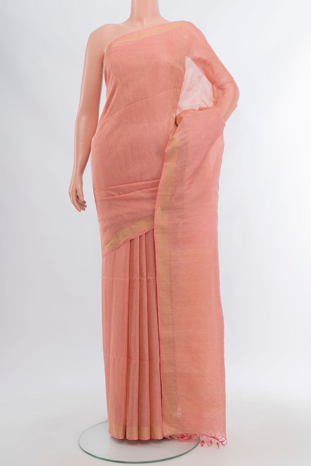 Coral Soft Silk Saree with Zari Butta on the body and Plain Border.  displayed on a mannequin