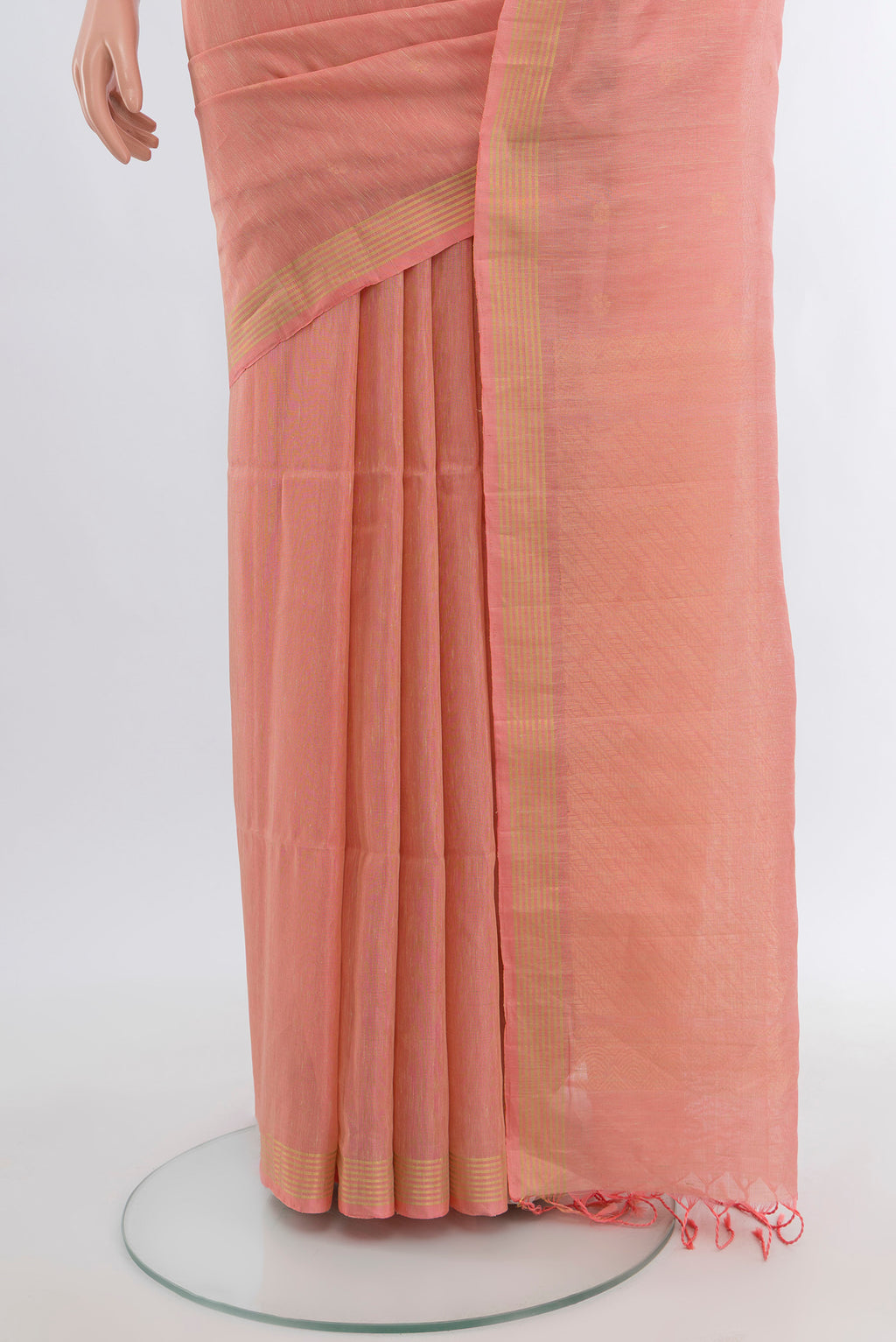 Pleats and pallu of Coral Soft Silk Saree with Zari Butta on the body and Plain Border. 