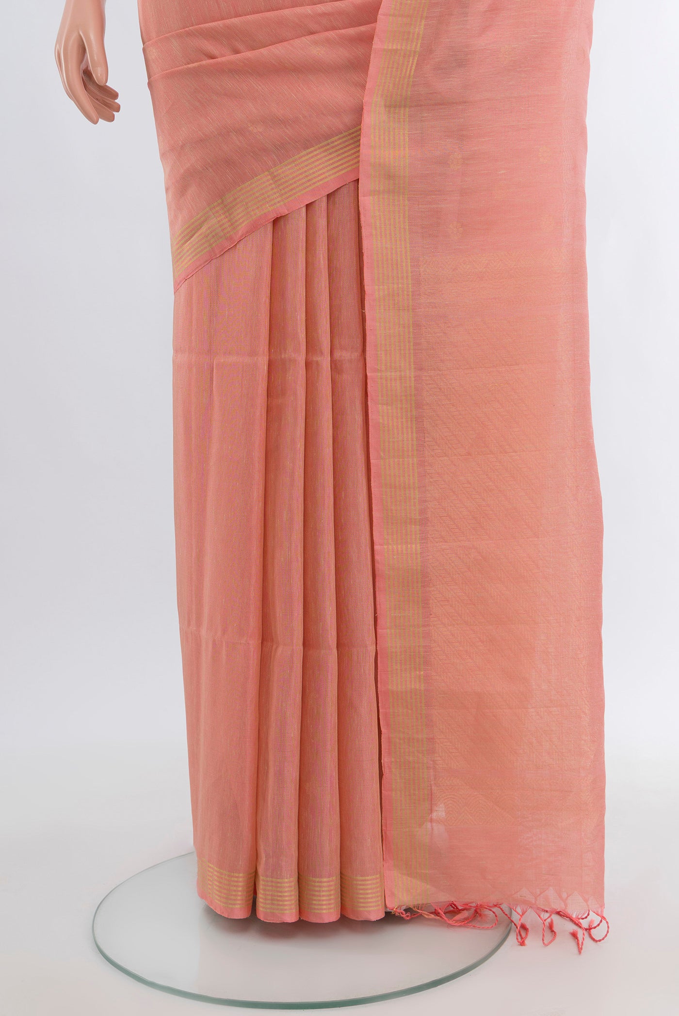 Pleats and pallu of Coral Soft Silk Saree with Zari Butta on the body and Plain Border. 