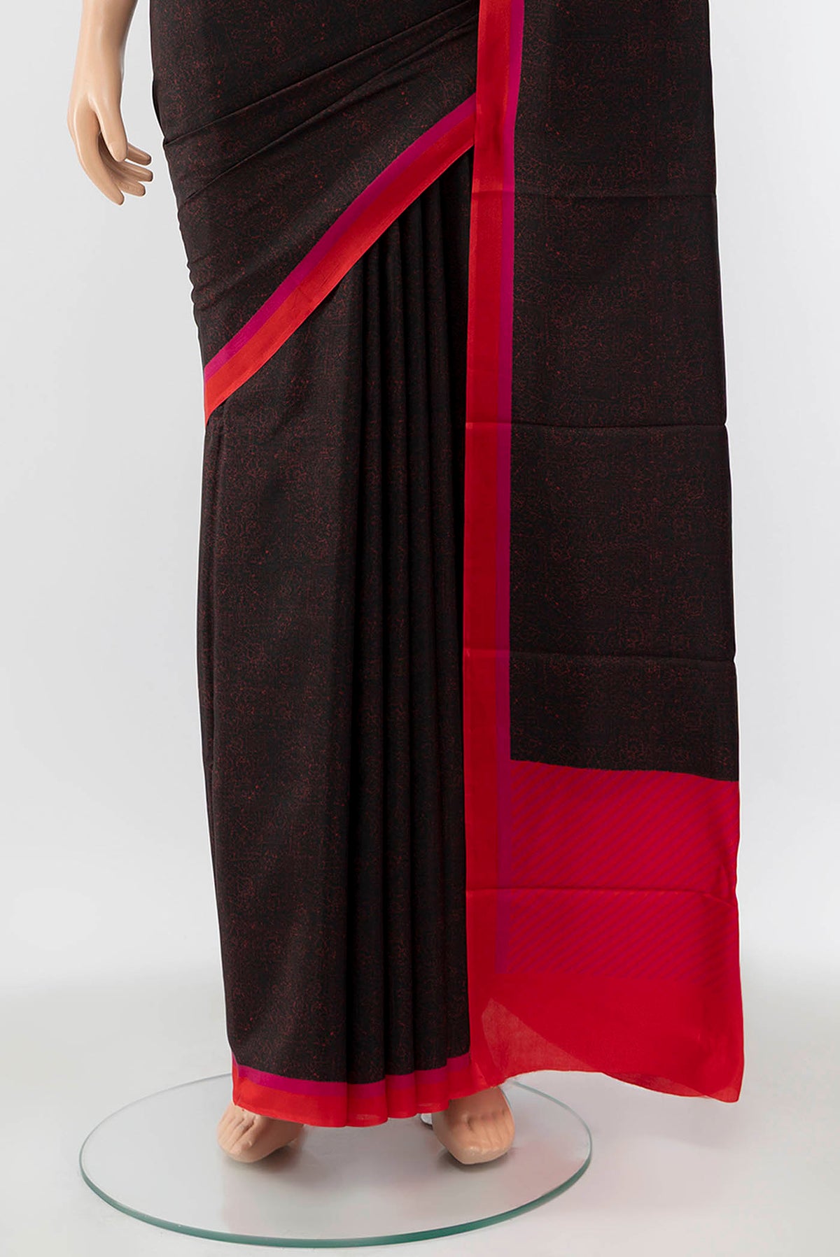 Pleats and pallu of Black Printed Silk Saree with Printed design on the body and Silk Border