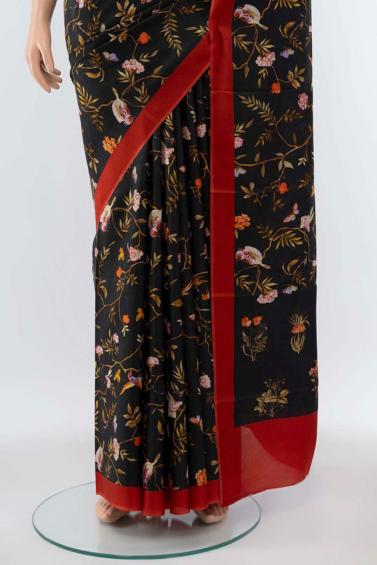 Pleats and pallu of Black Printed Silk Saree with Floral Print on the body and Silk Border