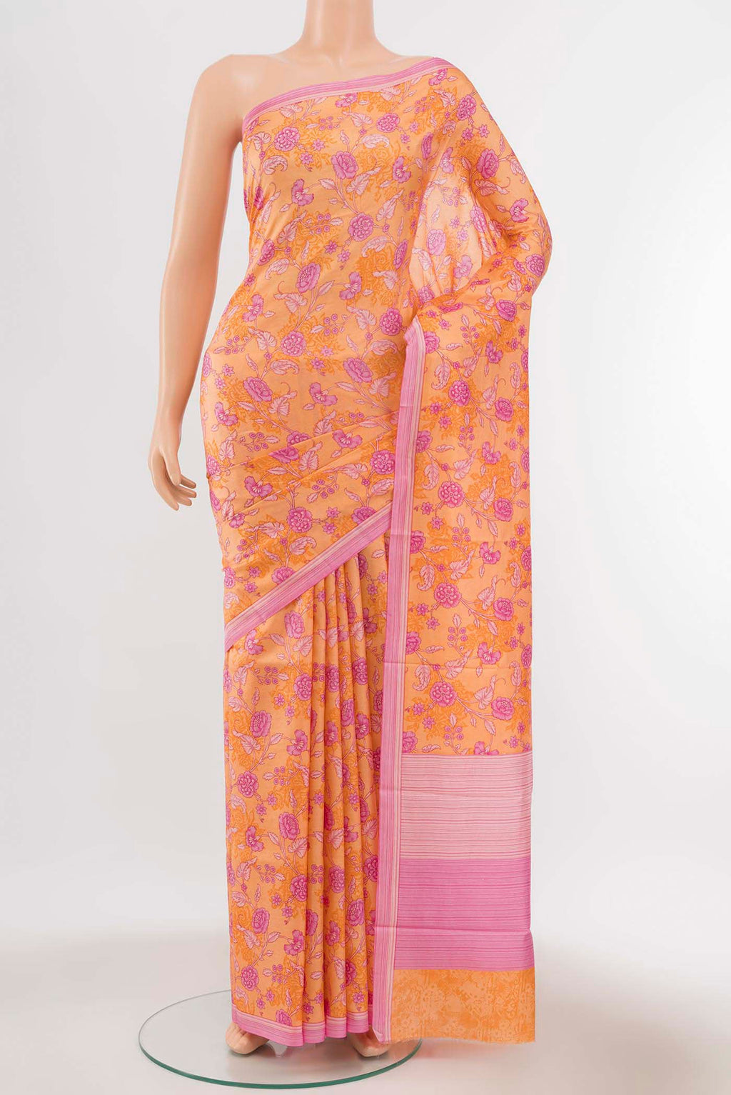 Orange Printed Silk Saree with Floral Print on the body and Silk Border displayed on a mannequin