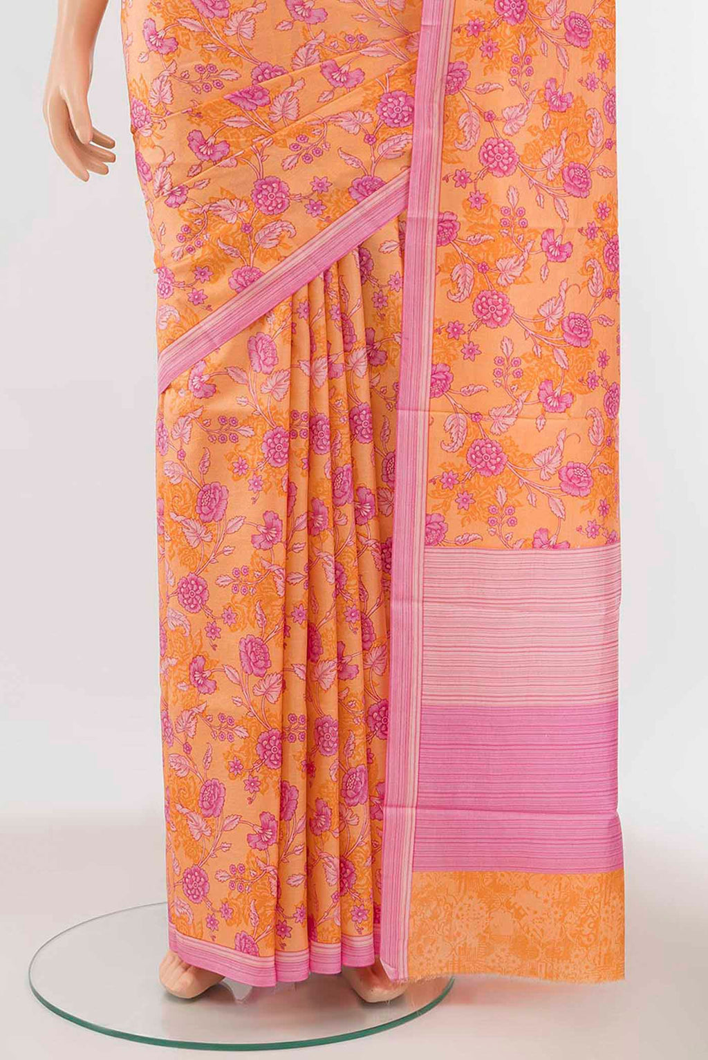 Pleats and pallu of Orange Printed Silk Saree with Floral Print on the body and Silk Border