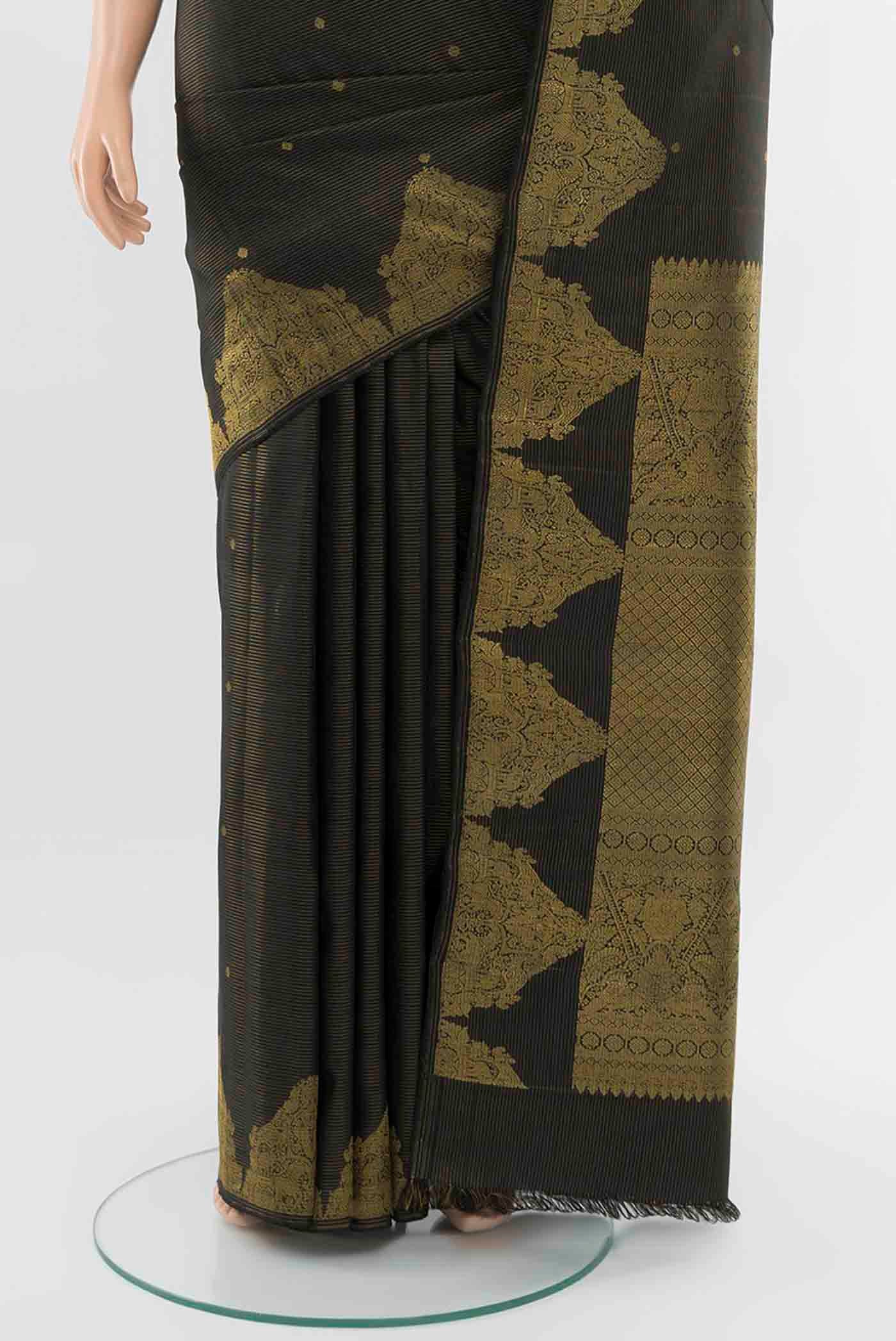 Pleats and pallu of Black Kanchipuram Silk Saree with Zari Butta on the body and Silk Border