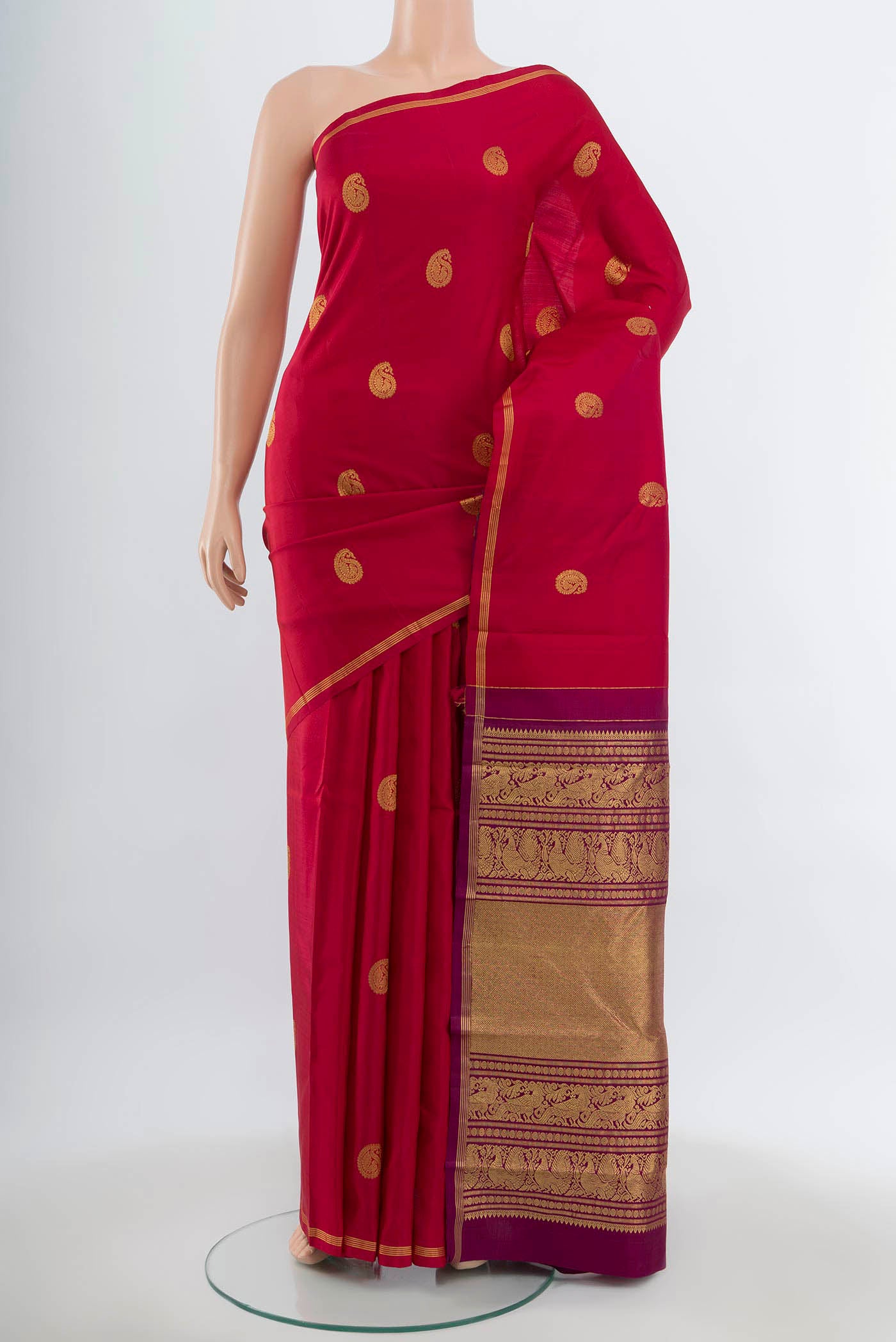 Maroon Kanchipuram Silk Saree with Zari Butta on the body and Silk Border.  displayed on a mannequin