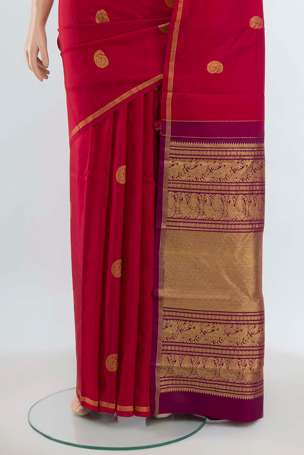 Pleats and pallu of Maroon Kanchipuram Silk Saree with Zari Butta on the body and Silk Border. 