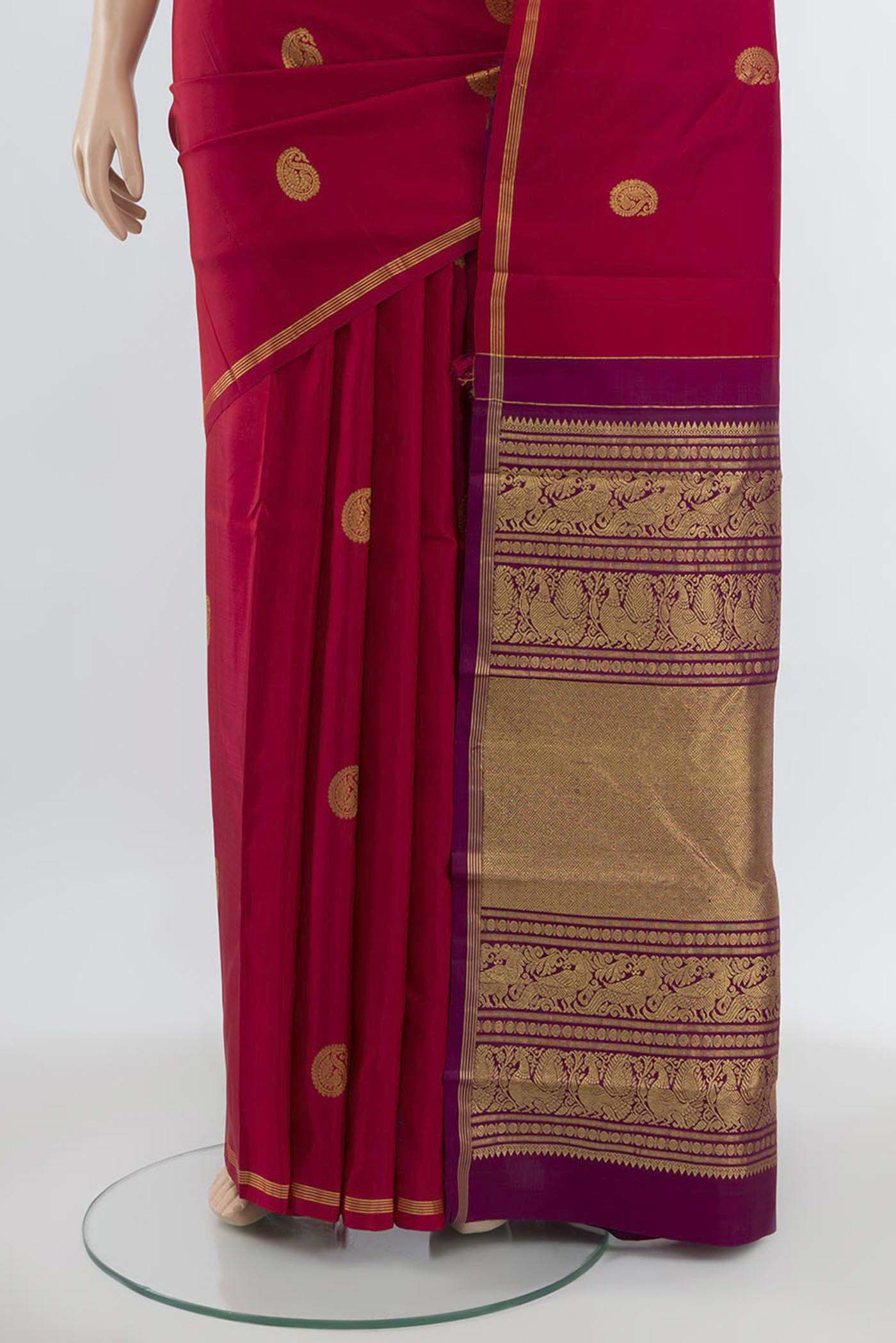 Pleats and pallu of Maroon Kanchipuram Silk Saree with Zari Butta on the body and Silk Border. 