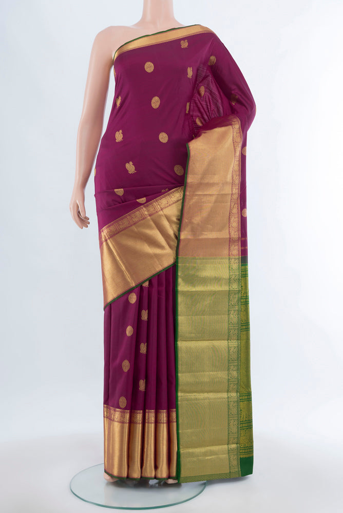 Purple Kanjivaram Silk Saree with Zari Butta on the body and Silk Border.  displayed on a mannequin