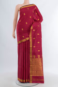 Maroon Kanjivaram Silk Saree with Zari Butta on the body and Zari Border.  displayed on a mannequin